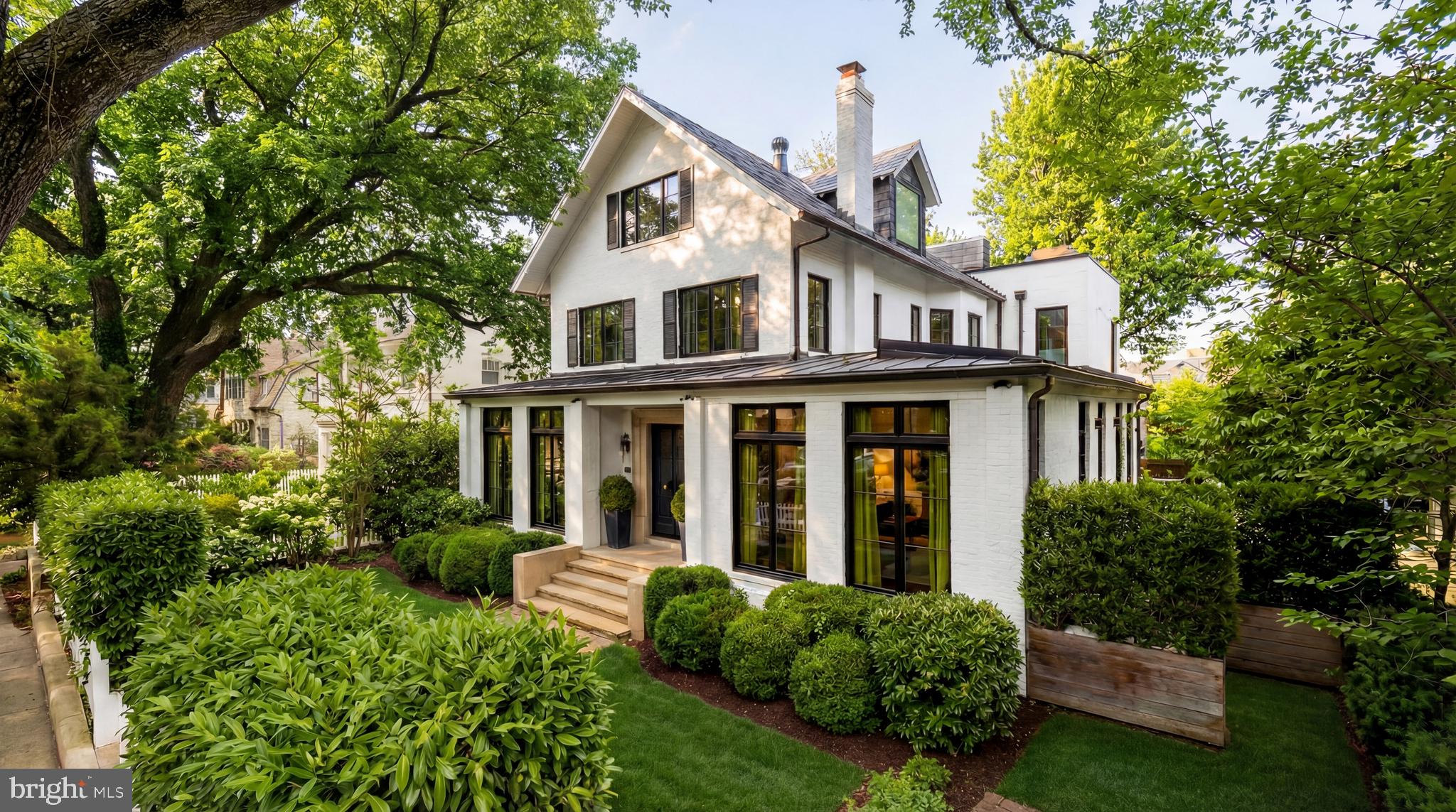 2709 36th Street Northwest Washington, DC 20007 - Photo 2 of 50 a view of a white house with large windows and a small yard