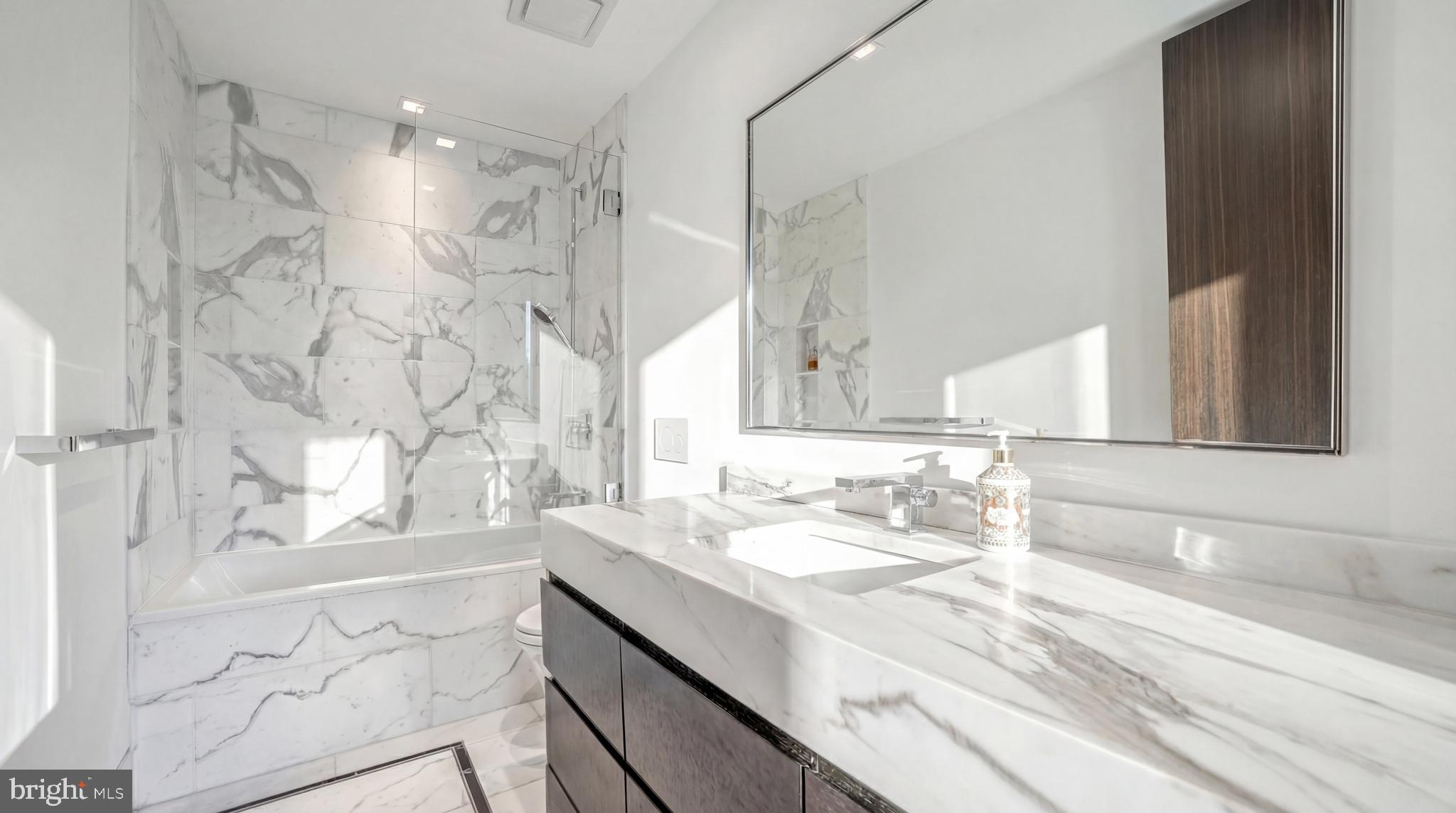 2709 36th Street Northwest Washington, DC 20007 - Photo 32 of 50 a bathroom with a sink vanity granite tub shower and a mirror