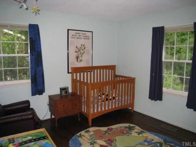 6307 Brandywine Road Raleigh, NC 27607 - Photo 11 of 12 a bedroom with a bed and a window