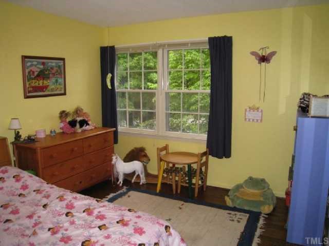 6307 Brandywine Road Raleigh, NC 27607 - Photo 12 of 12 a bedroom with a bed and wooden floor