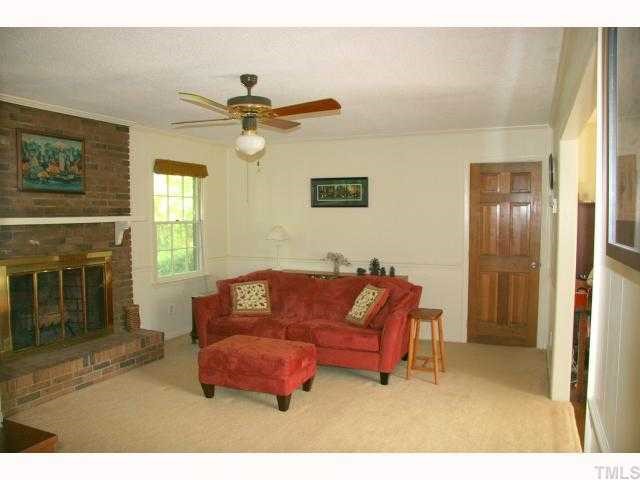 6307 Brandywine Road Raleigh, NC 27607 - Photo 5 of 12 a living room with furniture and a fireplace