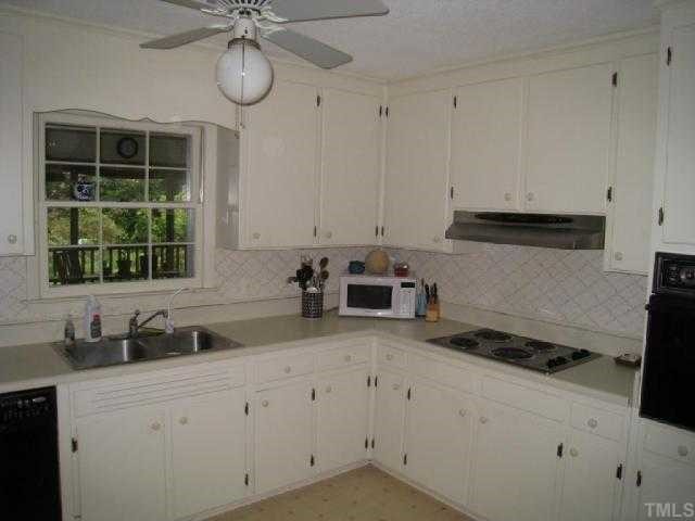 6307 Brandywine Road Raleigh, NC 27607 - Photo 8 of 12 a kitchen with appliances cabinets and a window
