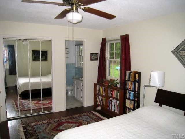 6307 Brandywine Road Raleigh, NC 27607 - Photo 10 of 12 a bedroom with a bed a window and cabinet