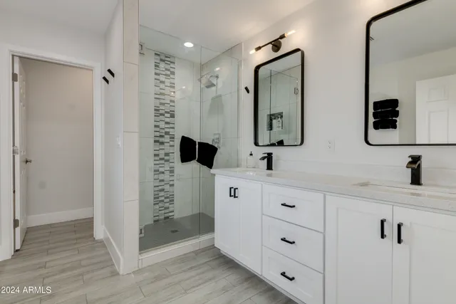 a bathroom with double vanity sink and mirror