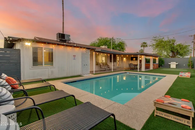 a view of a house with pool and chairs