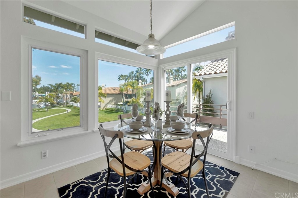 5639 Spinnaker Bay Drive Long Beach, CA 90803 - Photo 12 of 27 a view of a dining room with furniture a chandelier and wooden floor