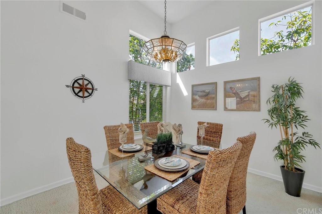 5639 Spinnaker Bay Drive Long Beach, CA 90803 - Photo 8 of 27 a dining room with furniture potted plants and wooden floor