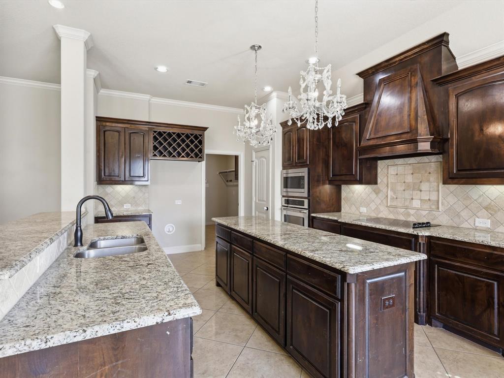 206 Brighton Court Midlothian, TX 76065 - Photo 4 of 15 a kitchen with stainless steel appliances granite countertop a sink stove and refrigerator