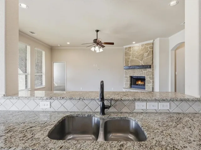 a kitchen with a sink and a mirror