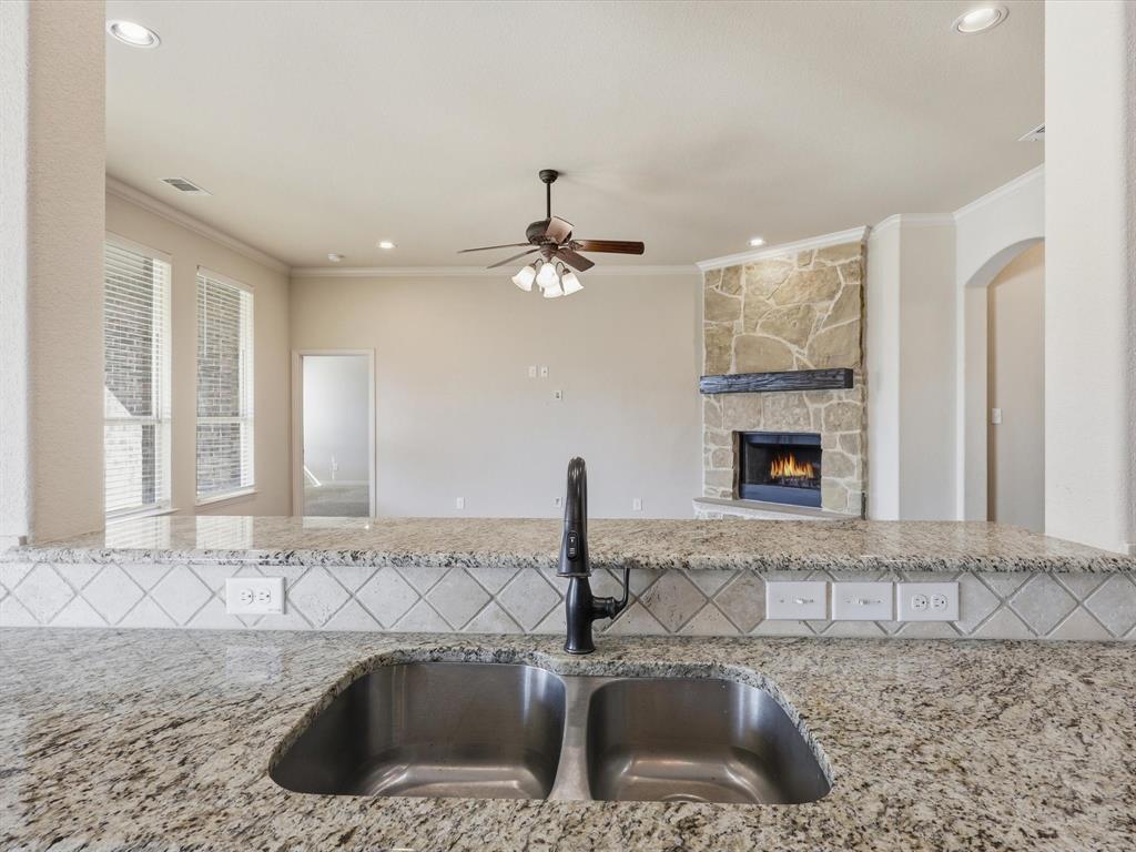 206 Brighton Court Midlothian, TX 76065 - Photo 6 of 15 a kitchen with a sink and a mirror