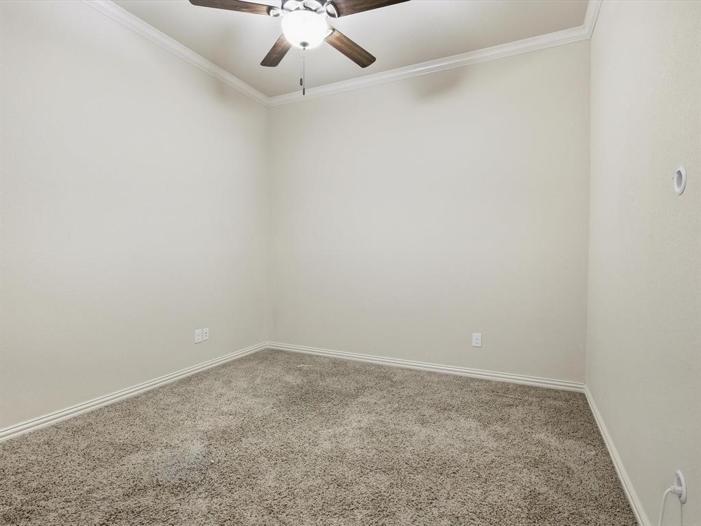 206 Brighton Court Midlothian, TX 76065 - Photo 10 of 15 an empty room with a chandelier fan and windows