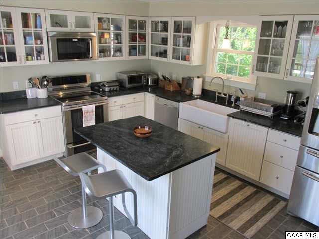 5585 Stony Point Road Barboursville, VA 22923 - Photo 6 of 28 a kitchen with stainless steel appliances granite countertop a stove a sink a microwave and a refrigerator