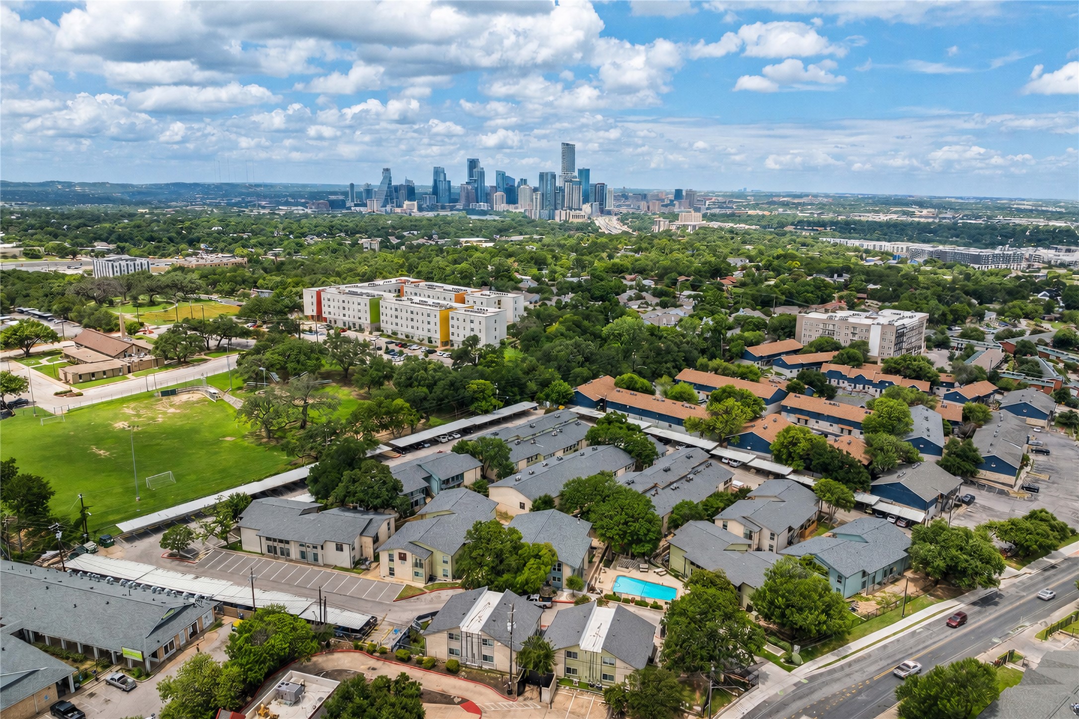 2124 Burton Drive, Unit 159 Austin, TX 78741 - Photo 21 of 23 An aerial perspective reveals a vibrant neighborhood with a city skyline backdrop.