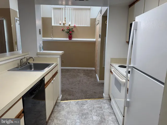 a view of staircase with lots of frames on wall