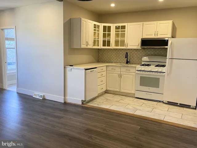 a kitchen with wooden cabinets and a stove top oven