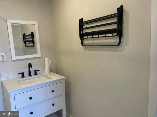 a view of a room with wooden floor and a ceiling fan