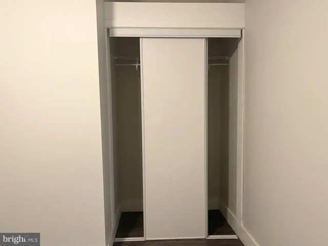 a view of a livingroom with wooden floor and a ceiling fan