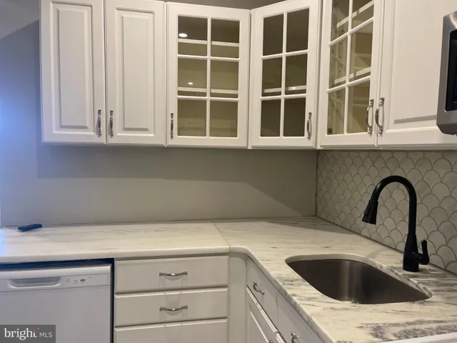 a kitchen with a refrigerator a stove top oven a sink and dishwasher