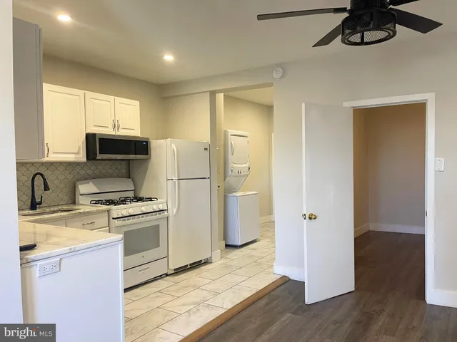 an empty room with wooden floor and cabinet