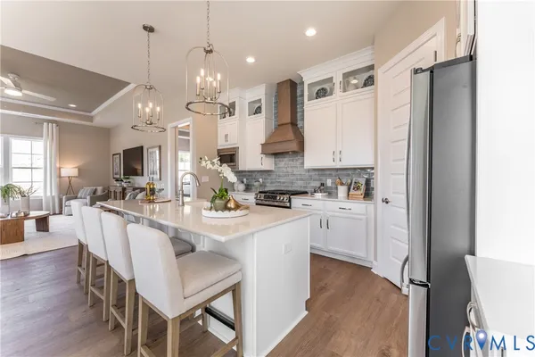a kitchen with kitchen island granite countertop a sink cabinets and wooden floor