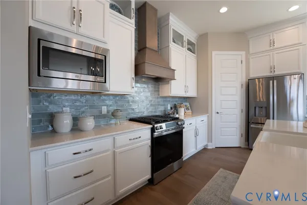 a kitchen with stainless steel appliances granite countertop a refrigerator sink and stove