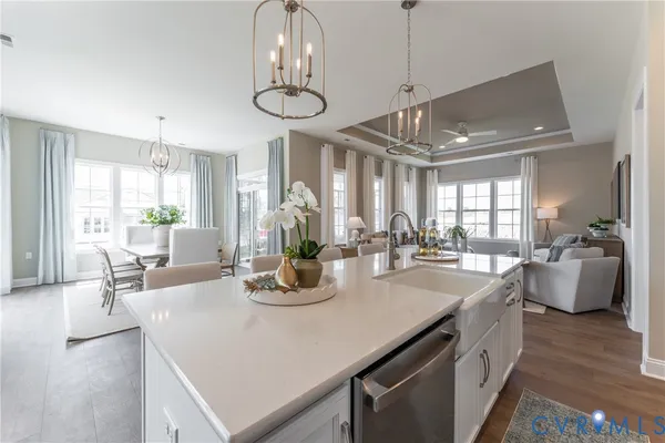 a kitchen with a table chairs and white cabinets