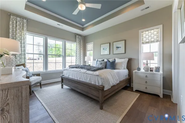 a bedroom with a large bed and a chandelier