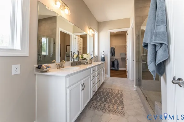 a bathroom with a double vanity sink and a mirror