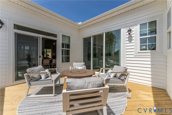 a view of a patio with a dining table and chairs