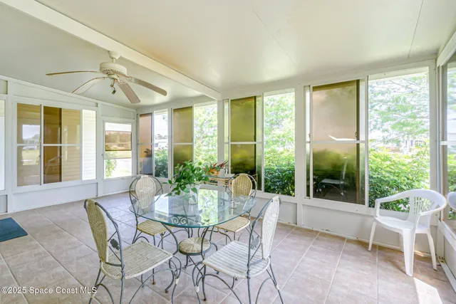 a dining room with furniture window and outside view