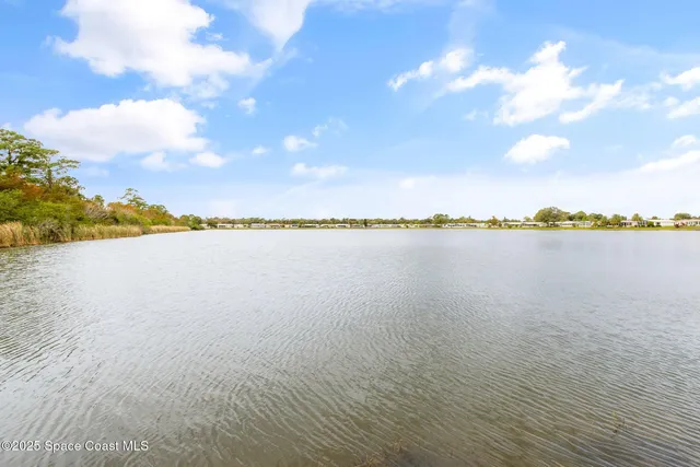a view of a lake with houses in the back