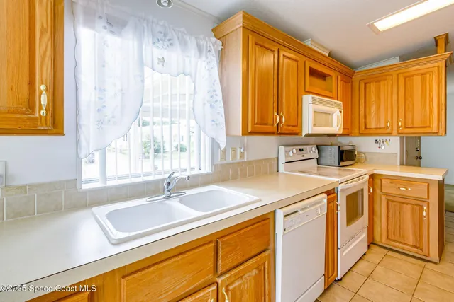 a kitchen with stainless steel appliances granite countertop a sink and a window