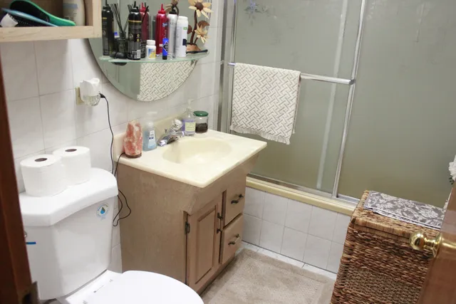a bathroom with a sink a toilet and shower