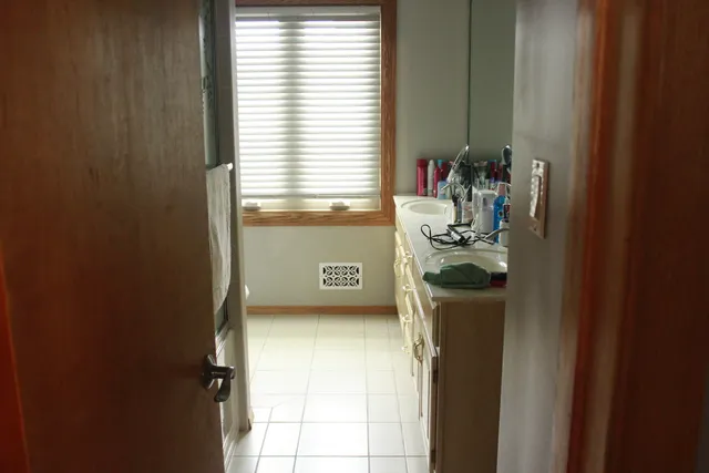 a large bed sitting in a bedroom next to a window