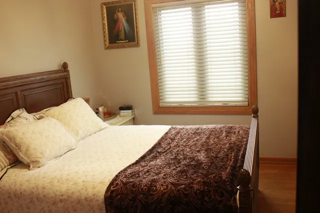 a large bed sitting in a bedroom next to a window