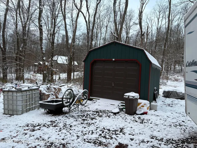 a view of a couches and fire pit in the backyard