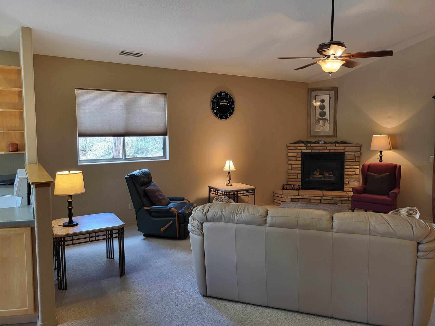1120 South Sycamore Circle Payson, AZ 85541 - Photo 10 of 44 a living room with furniture a fireplace and a window