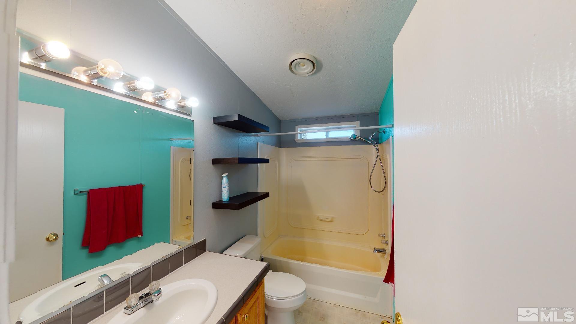 230 Danforth Drive Sun Valley, NV 89433 - Photo 19 of 28 a bathroom with a sink a toilet and shower