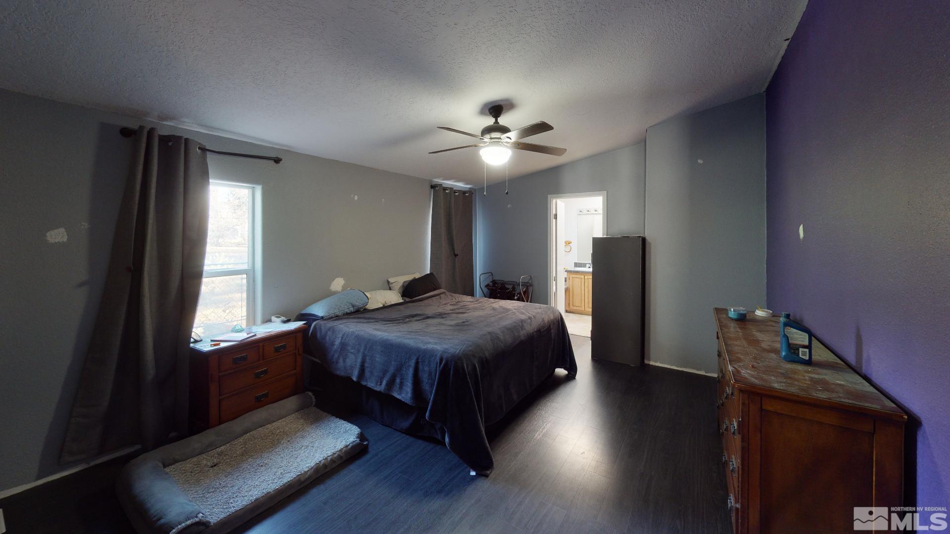 230 Danforth Drive Sun Valley, NV 89433 - Photo 22 of 28 a bedroom with a bed ceiling fan and a window