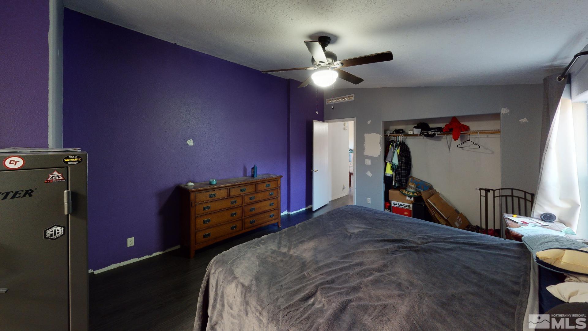 230 Danforth Drive Sun Valley, NV 89433 - Photo 23 of 28 a bed room with a bed and a ceiling fan