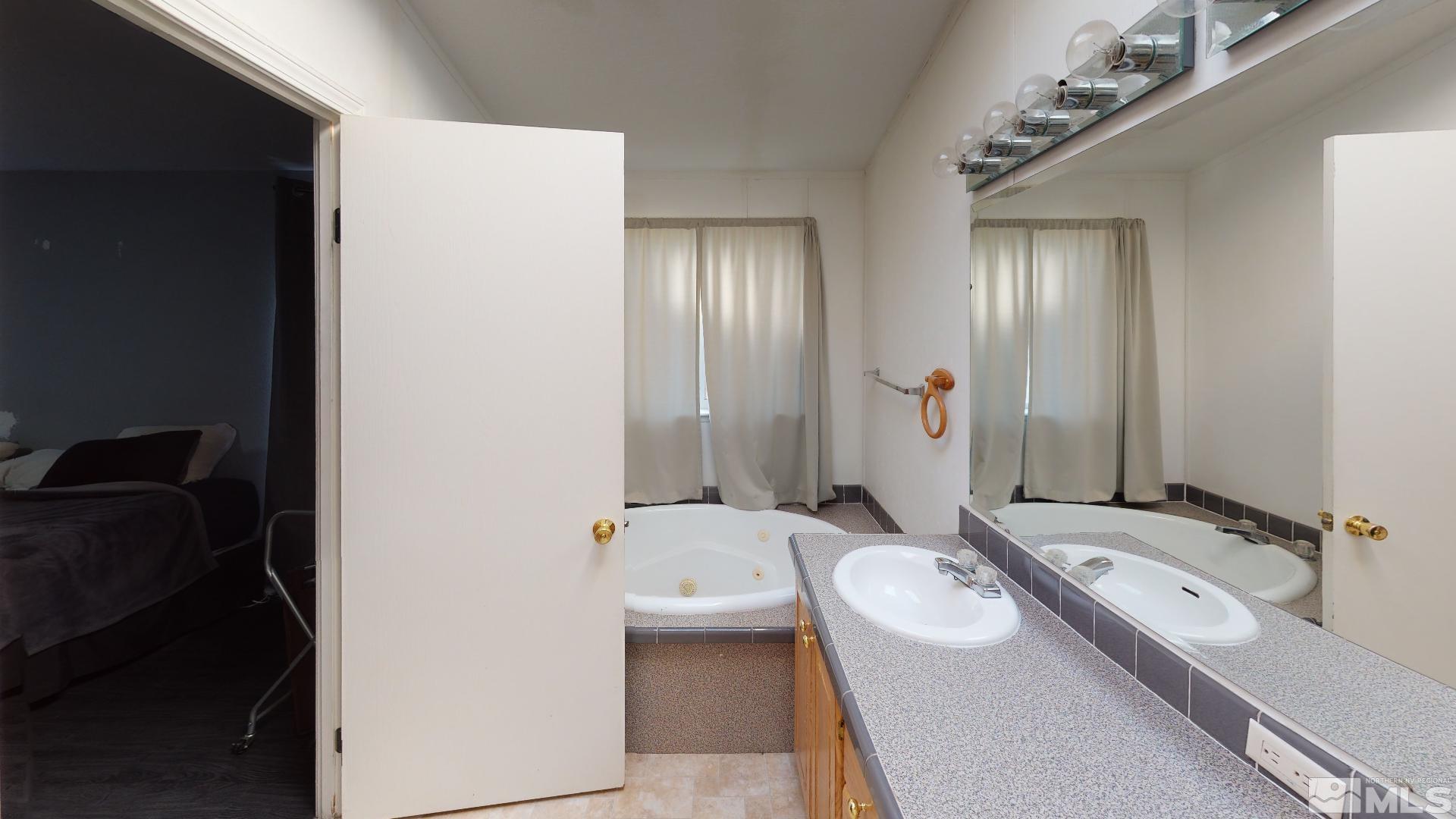 230 Danforth Drive Sun Valley, NV 89433 - Photo 24 of 28 a bathroom with a double vanity sink and mirror