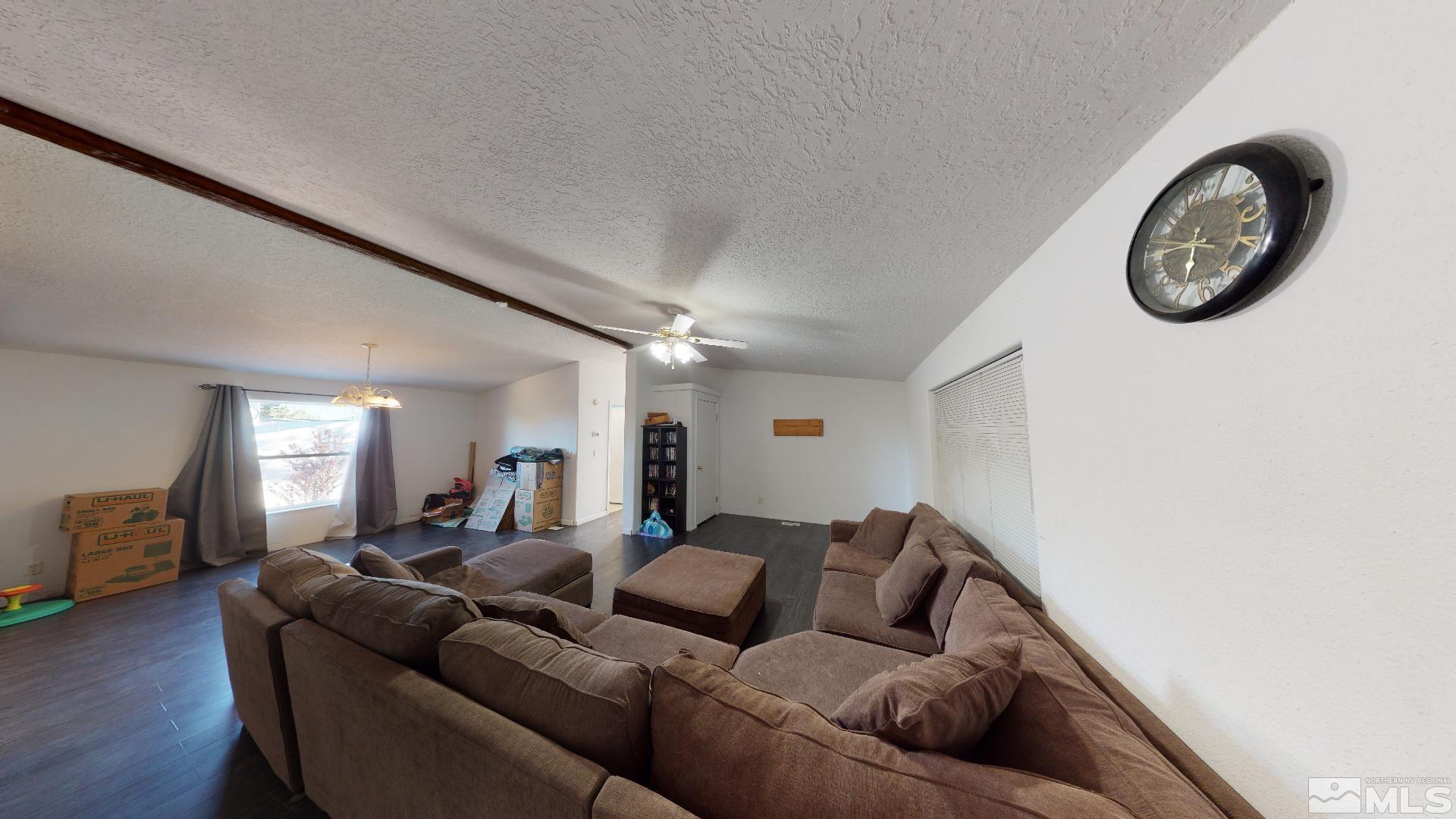 230 Danforth Drive Sun Valley, NV 89433 - Photo 8 of 28 a living room with furniture a mirror and a wall painting