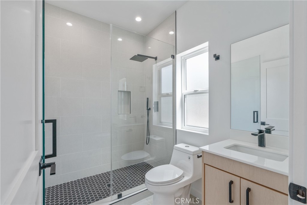 11142 Woodley Avenue Granada Hills, CA 91344 - Photo 3 of 11 a bathroom with a sink a toilet and shower