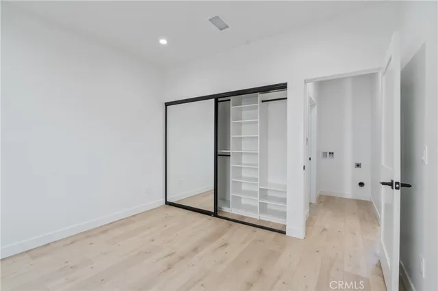 an empty room with wooden floor