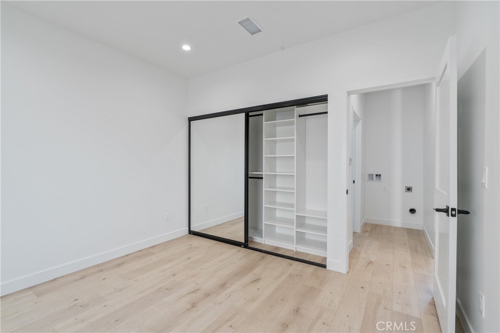 11142 Woodley Avenue Granada Hills, CA 91344 - Photo 5 of 11 an empty room with wooden floor