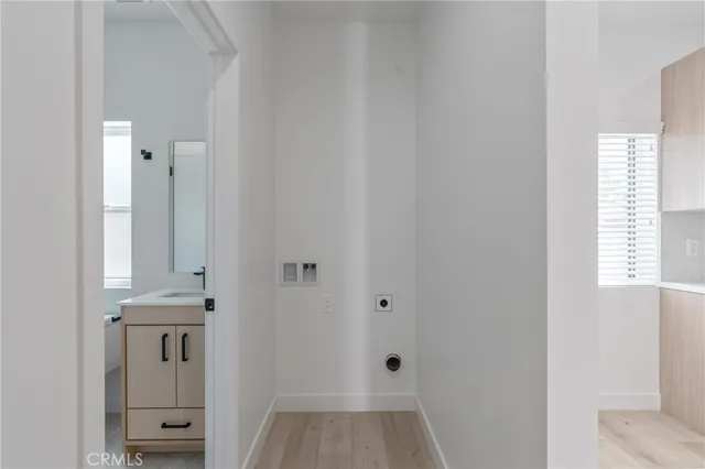 a view of a hallway with windows and cabinet