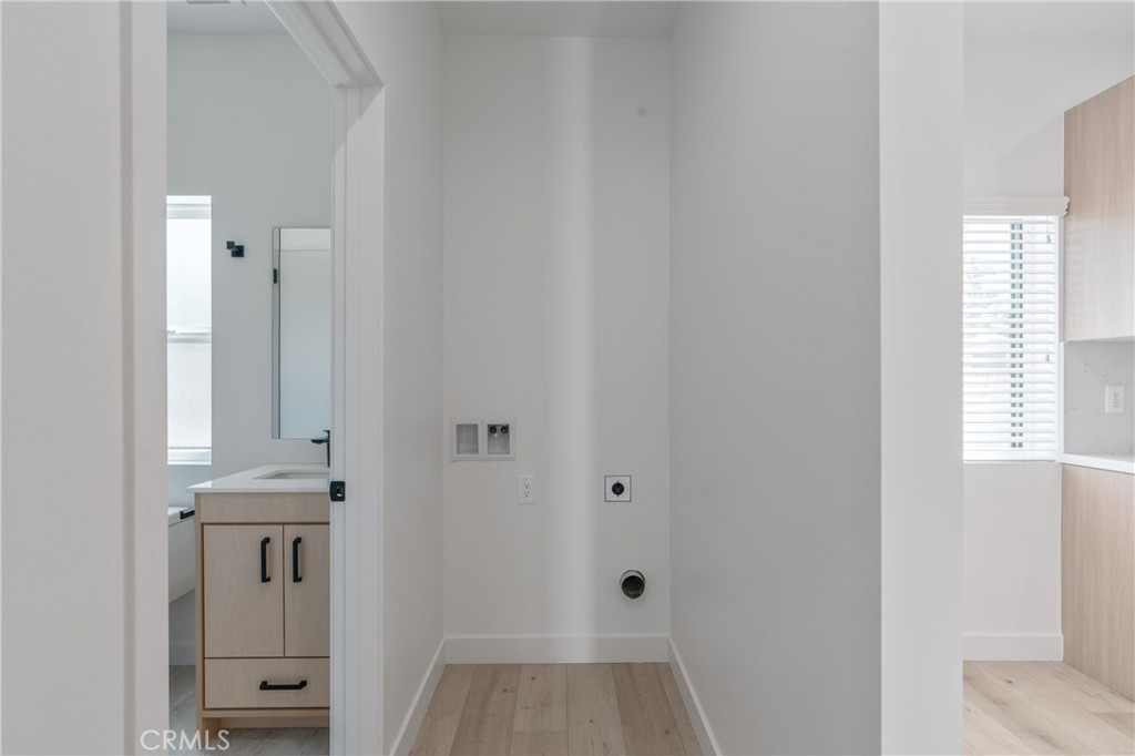 11142 Woodley Avenue Granada Hills, CA 91344 - Photo 6 of 11 a view of a hallway with windows and cabinet
