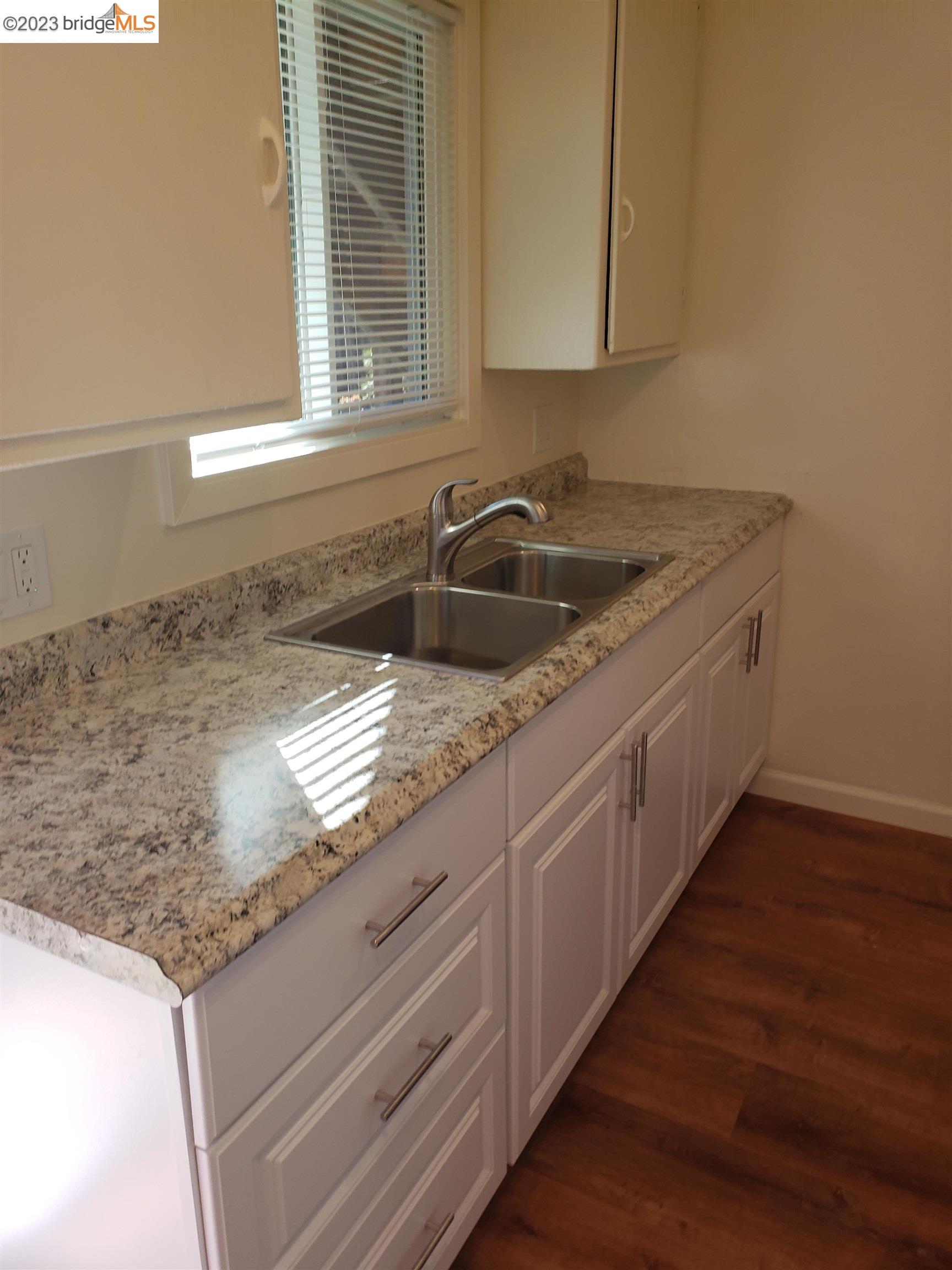 1408 Berkeley Way Berkeley, CA 94702 - Photo 5 of 7 a kitchen with granite countertop a sink and a window