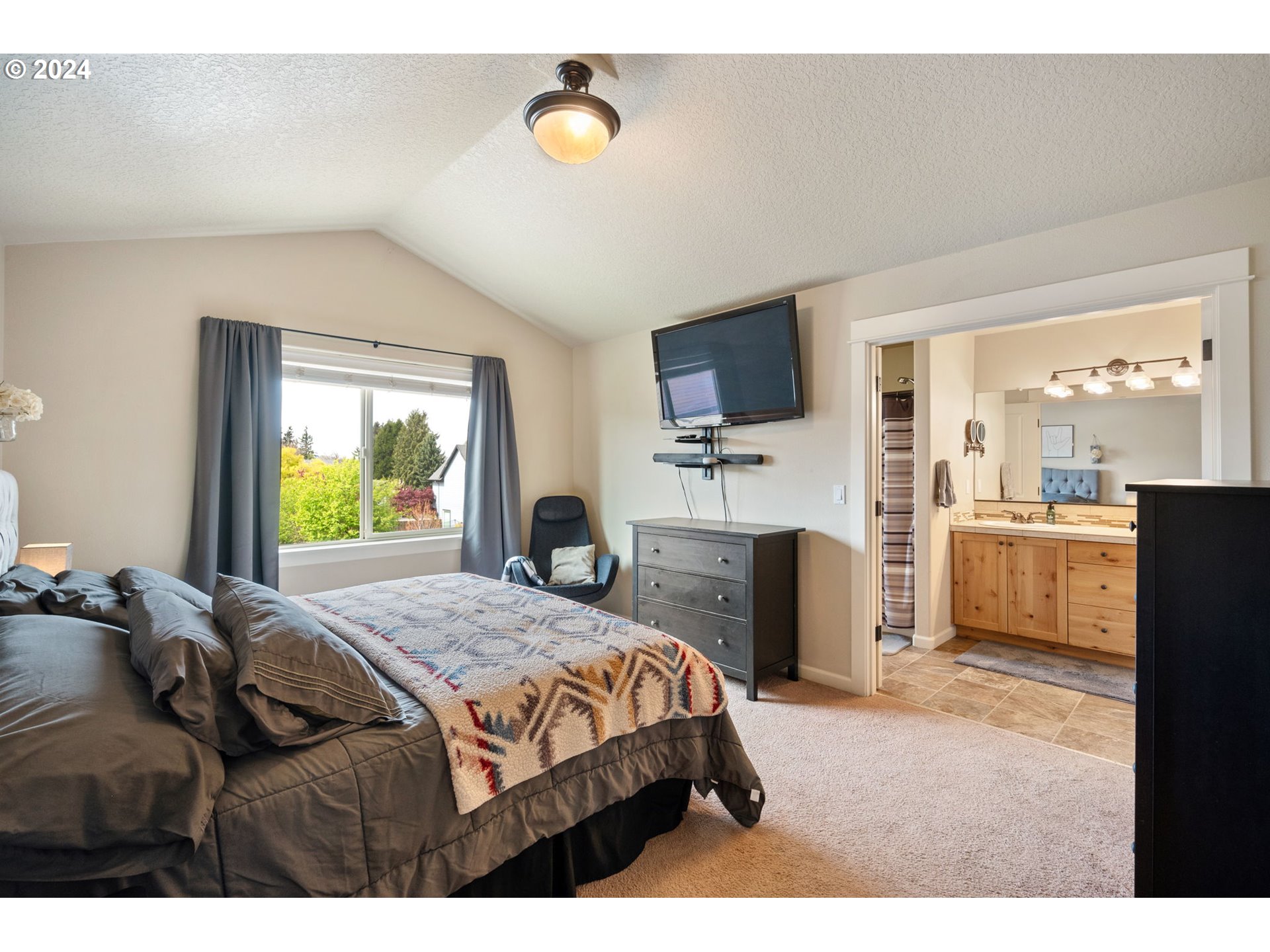 18438 Shadow Ridge Way Oregon City, OR 97045 - Photo 16 of 38 a bedroom with a bed and a flat screen tv