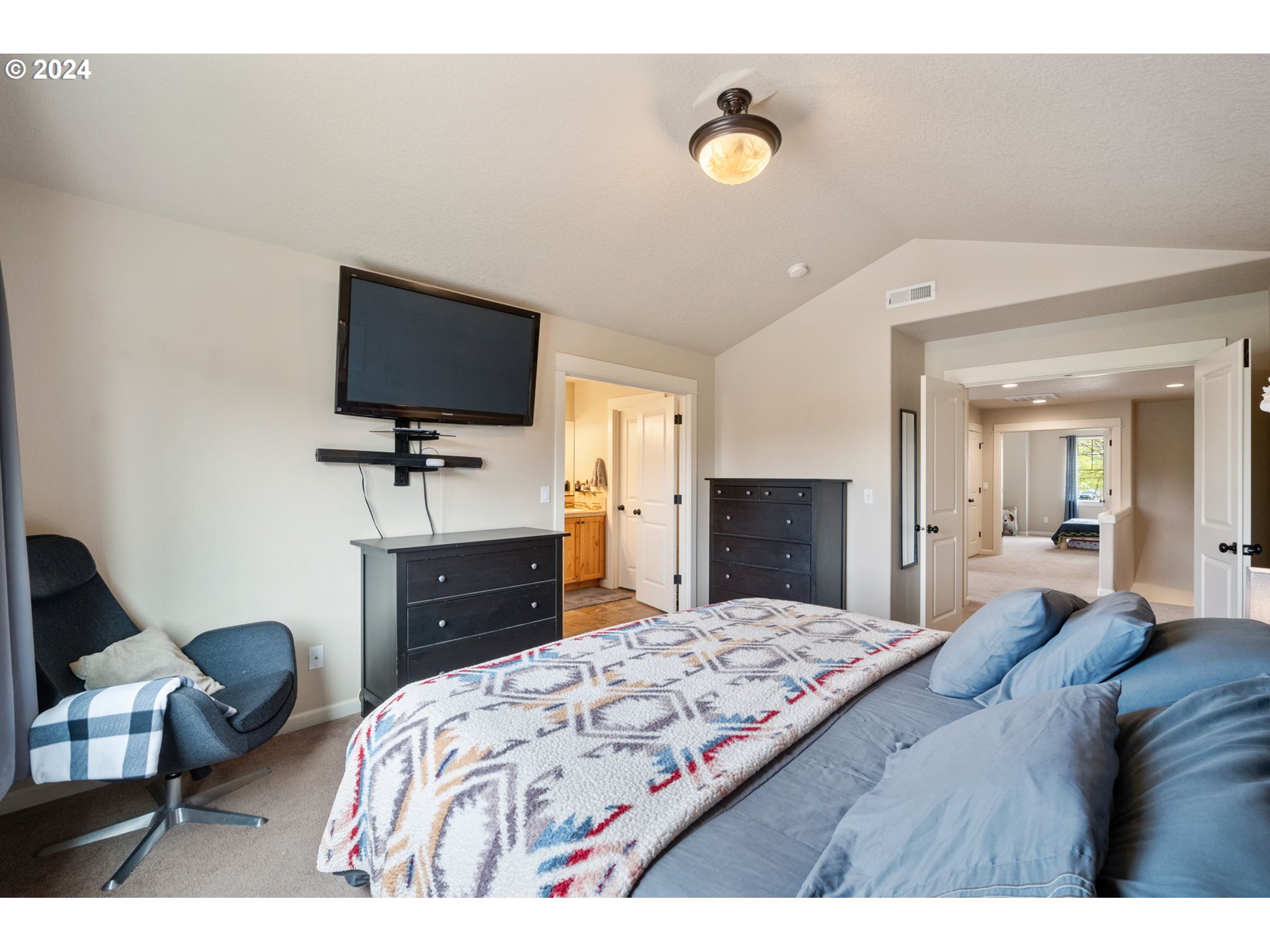 18438 Shadow Ridge Way Oregon City, OR 97045 - Photo 18 of 38 a bedroom with a bed and a flat screen tv